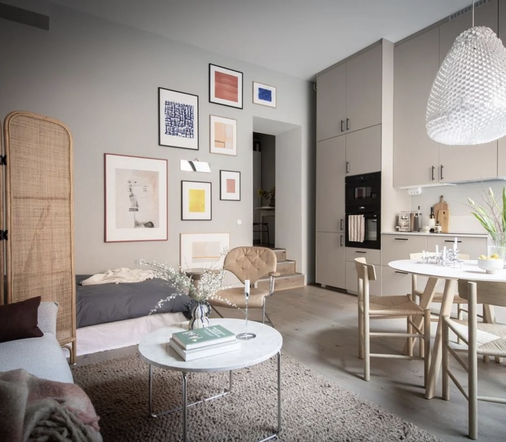 A Studio Apartment With High Ceilings And a Tall Beige Kitchen