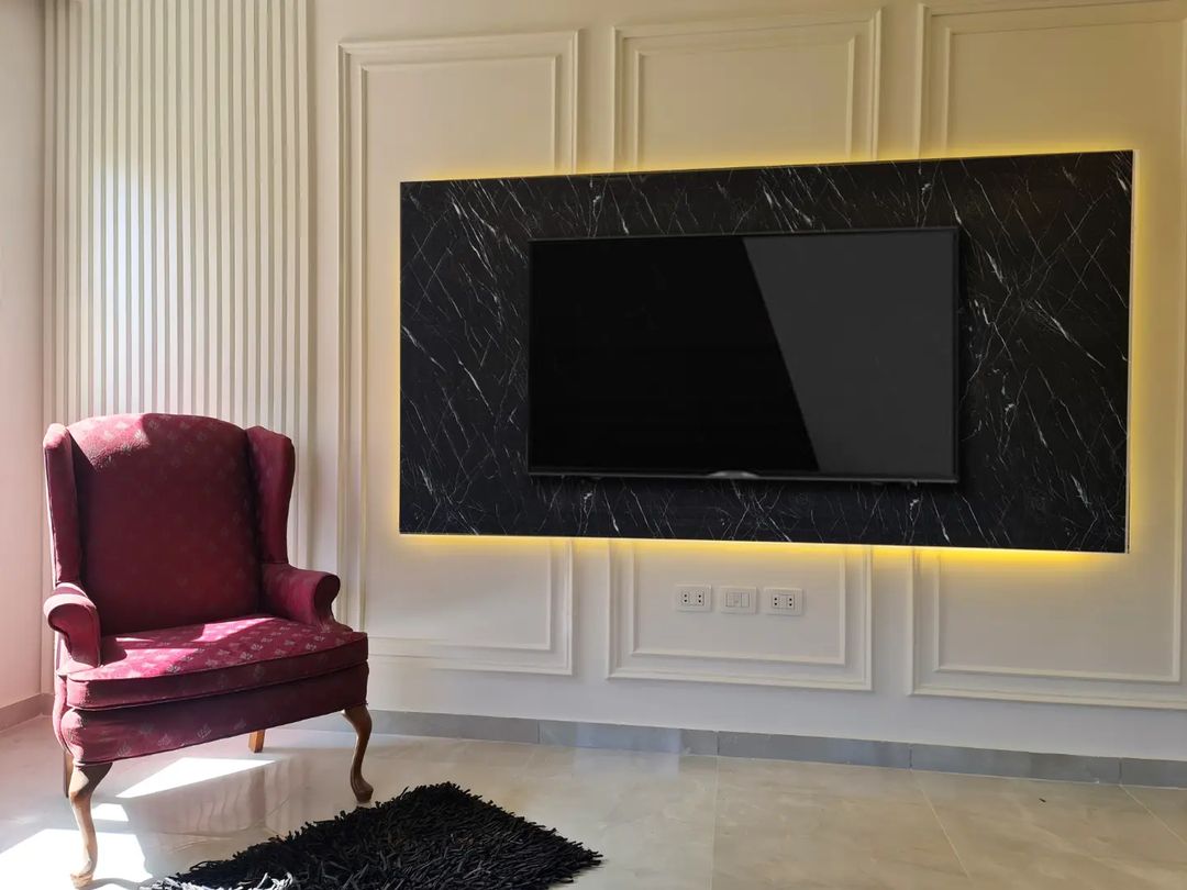 Marble TV Frame Over Board And Batten Accent Wall