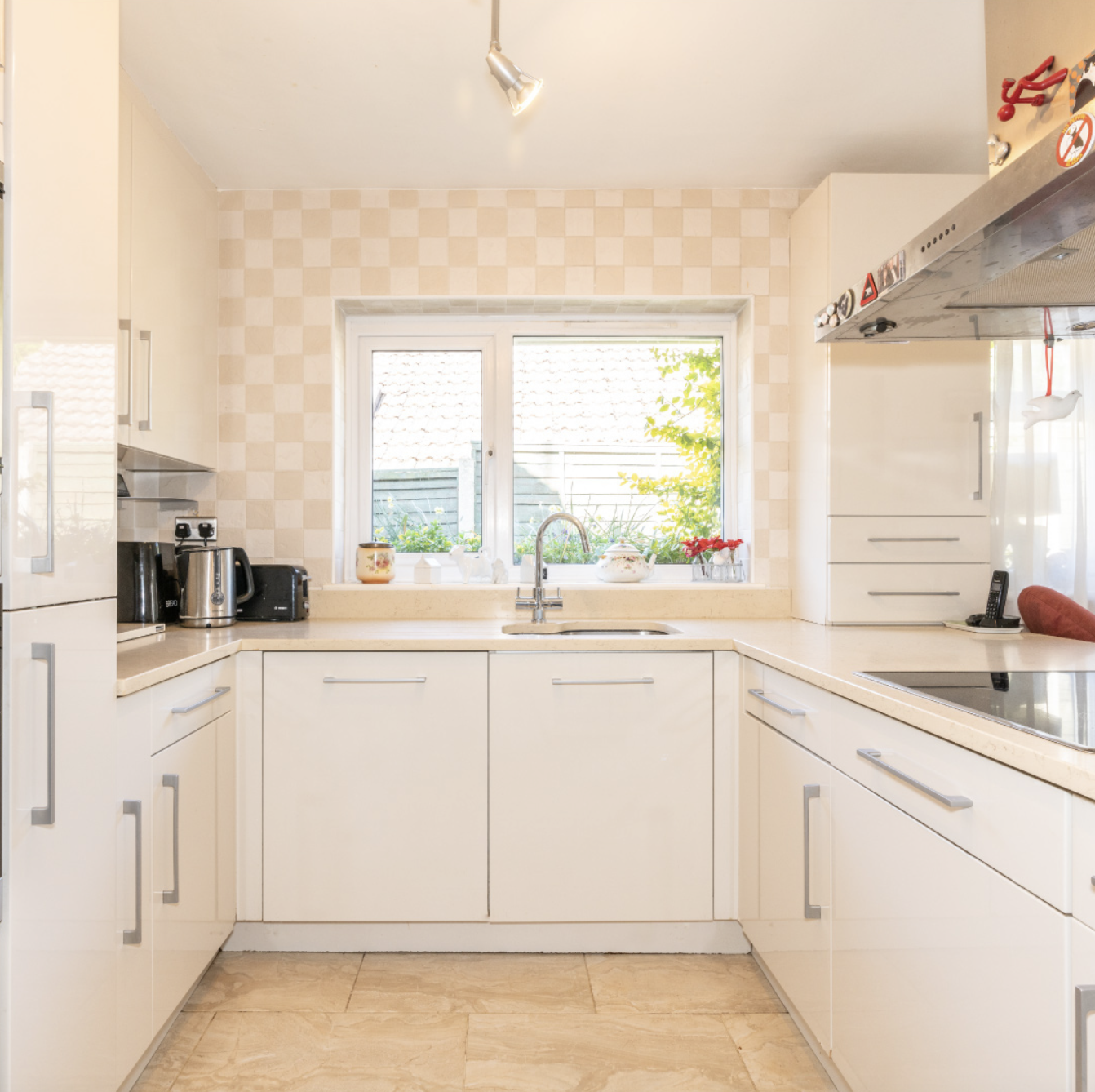 Neutral Color U-shaped Kitchen With Checkered Backsplash