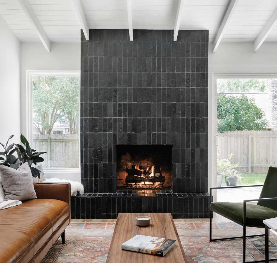 Black Mantel Fireplace With Brown Couch