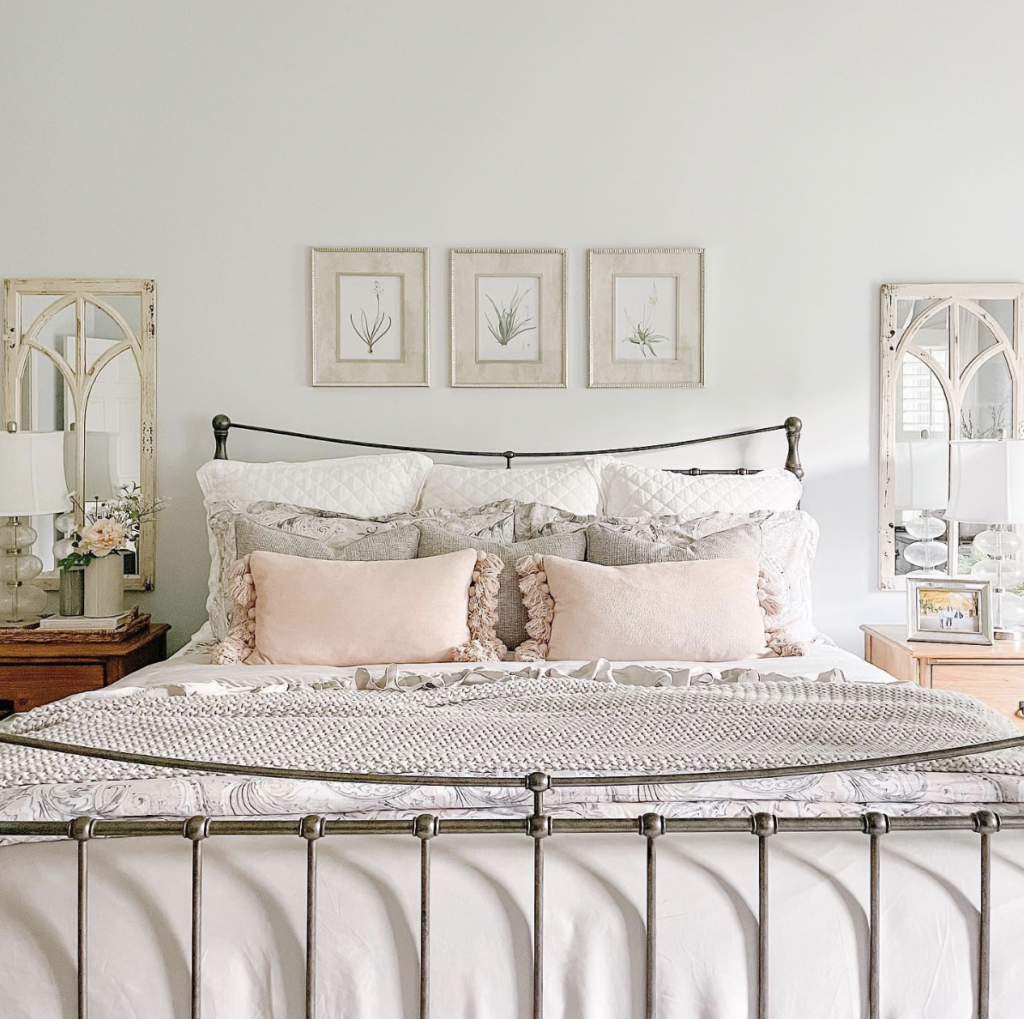 Distressed Wooden Frame Mirrors On Both Sides Of Bed Above Night Stands 