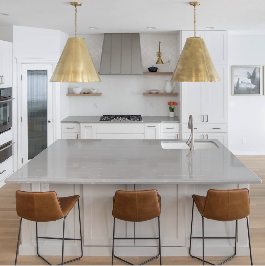 Grey Countertops Kitchen Paired With Gold Light Fixtures