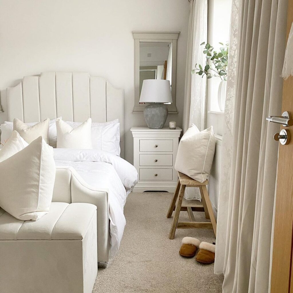 Neutral Color Bedroom With White Bedside Tables And Mirror Behind 
