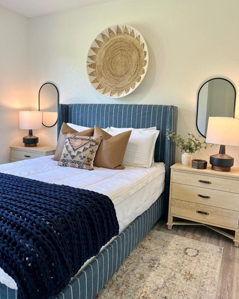 Blue Stripped Bed In A Boho-Theme Bedroom With Mirrors On Both Sides 