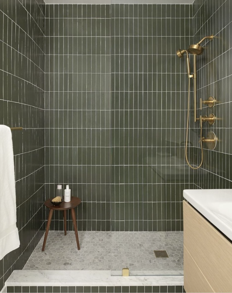 Forest Green Vertical stack Tile Design With Grey Floor Tiles And Gold Fixtures