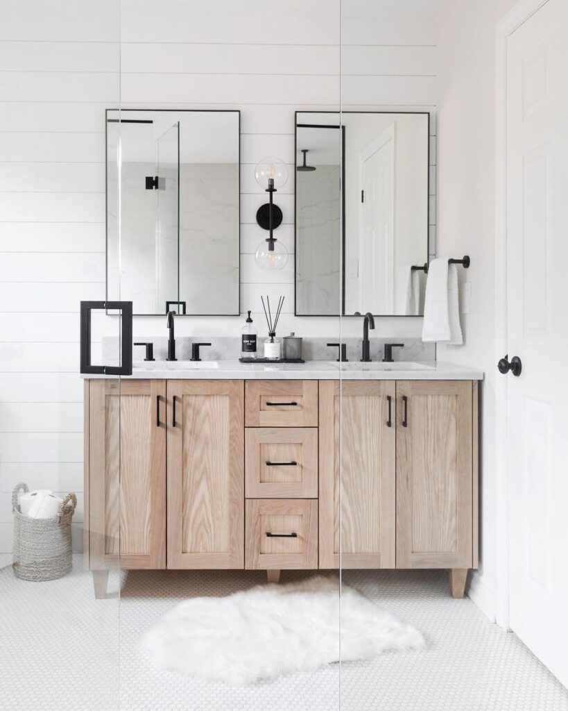 White Bathroom With Light Wood Vanity And Black Hardware
