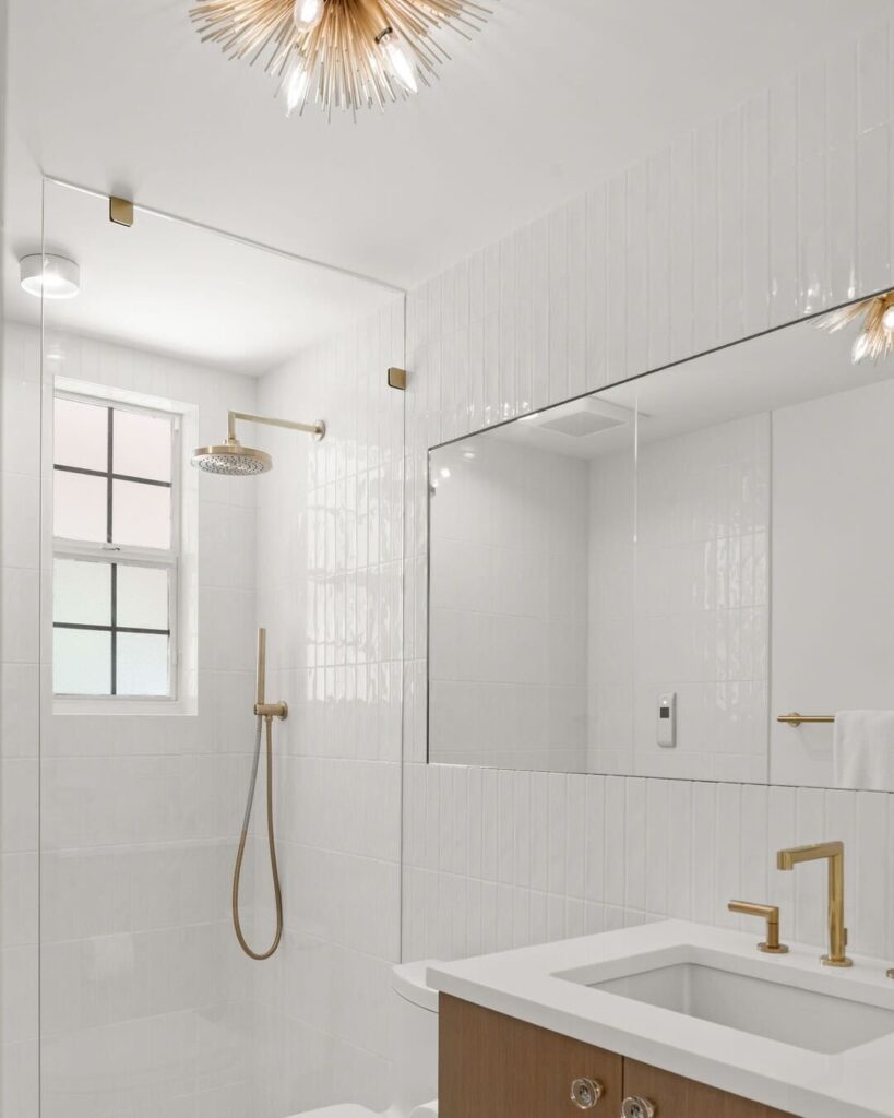 White Shower Wall With Gold Hardware