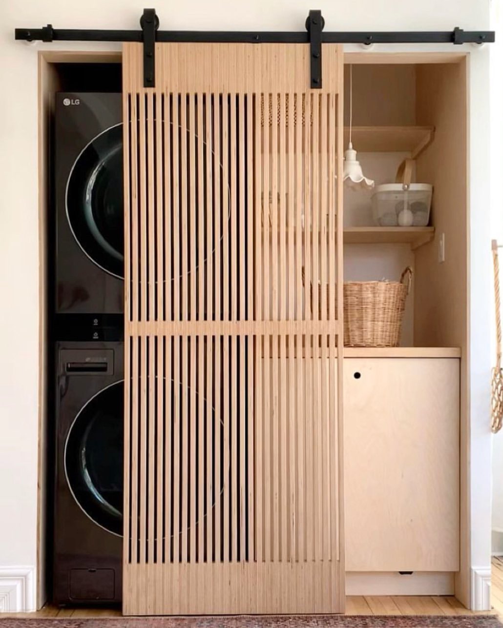 Minimalist Sliding Barn Door Laundry Room With A Stacked Washer Dryer