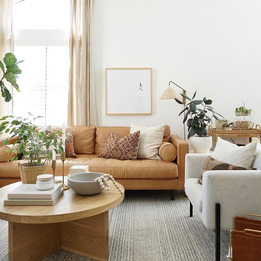 Scandinavian Serenity: A Brown Leather Couch with Nature-Inspired Accents