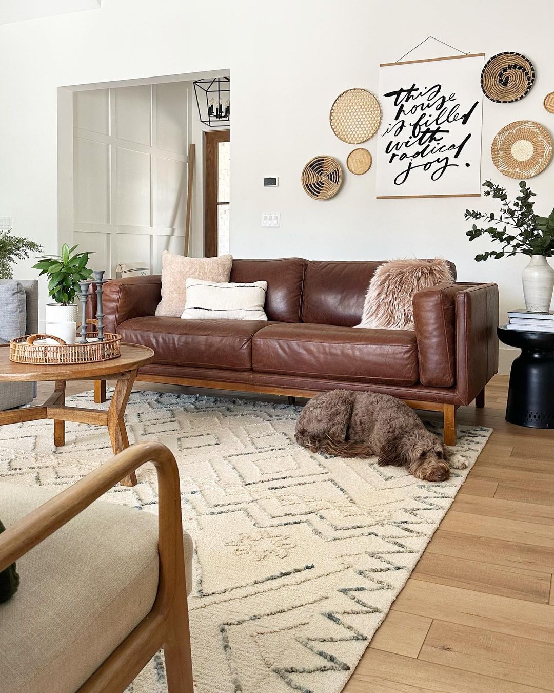 Artisanal Warmth: Woven Wall Decor and a Brown Leather Couch