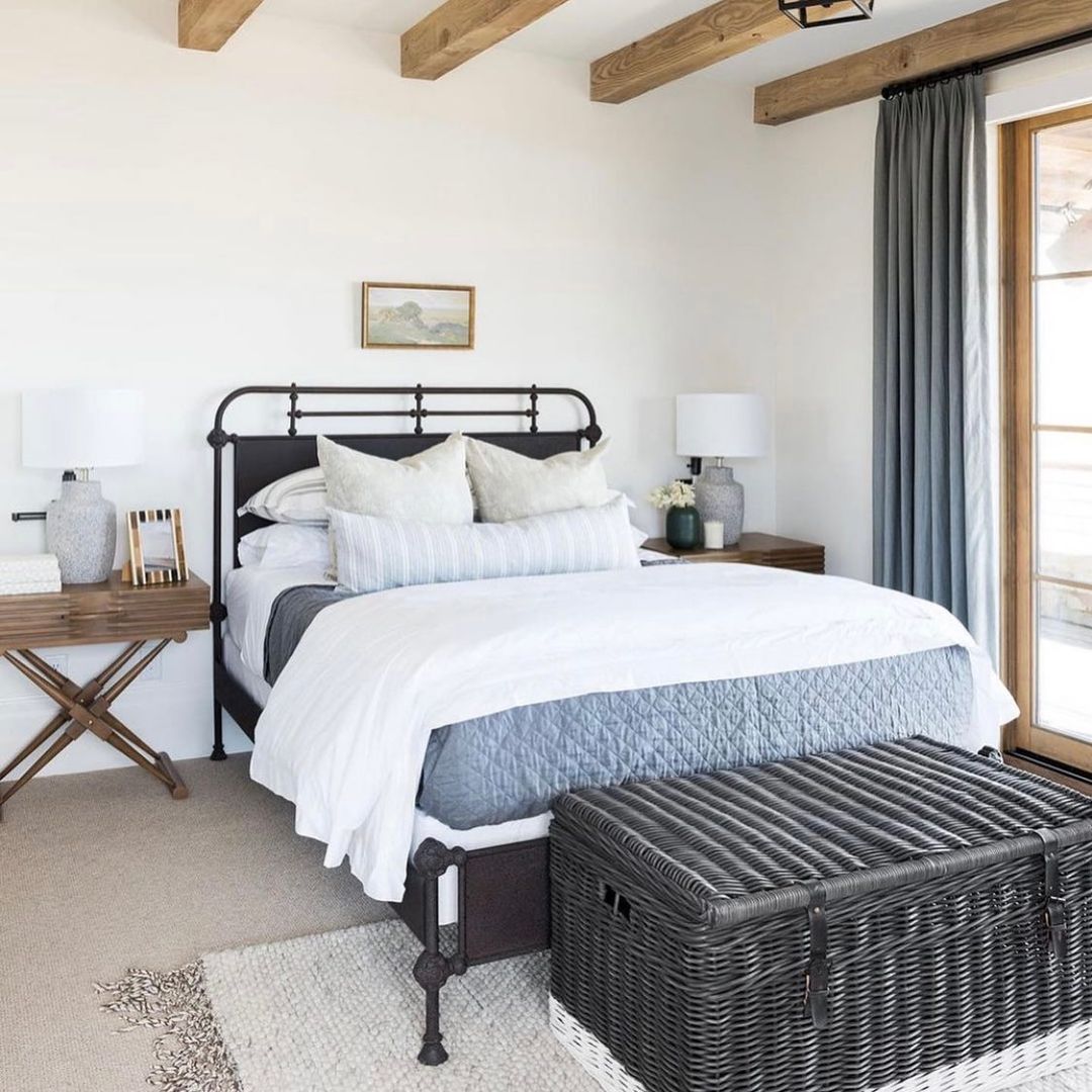 Rustic Retreat: Iron Bed Frame with Textured Layers