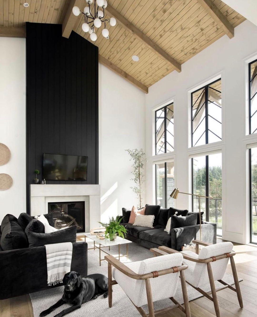 Black Couches in a High Ceiling Living Room