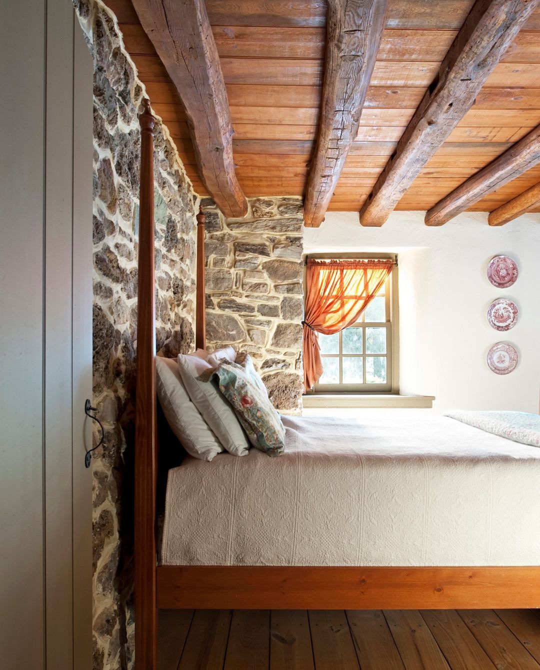 Exposed Stone Walls with Wooden Beams for Timeless Bedrooms