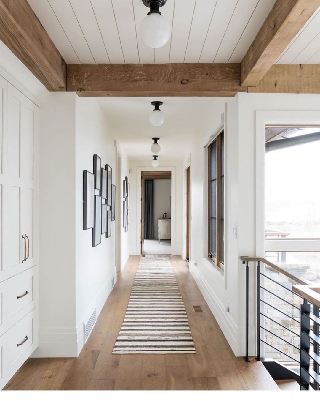 Define Long Hallways with Shiplap Ceilings and Rustic Beams