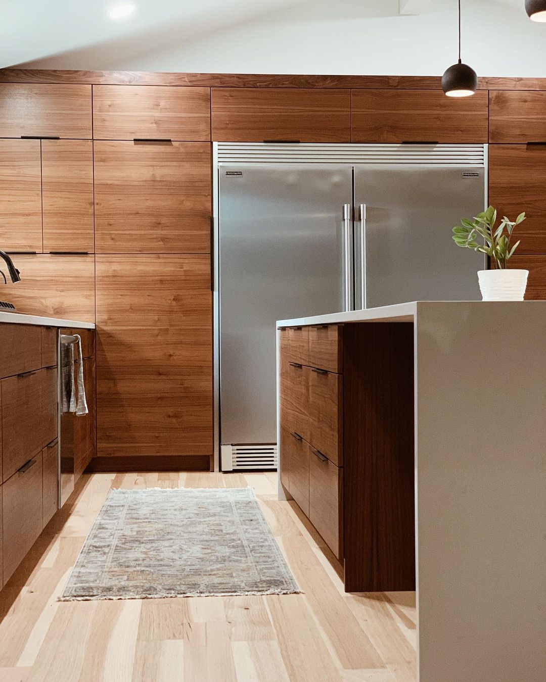 Streamlined Modernity with Warm Wood Cabinets