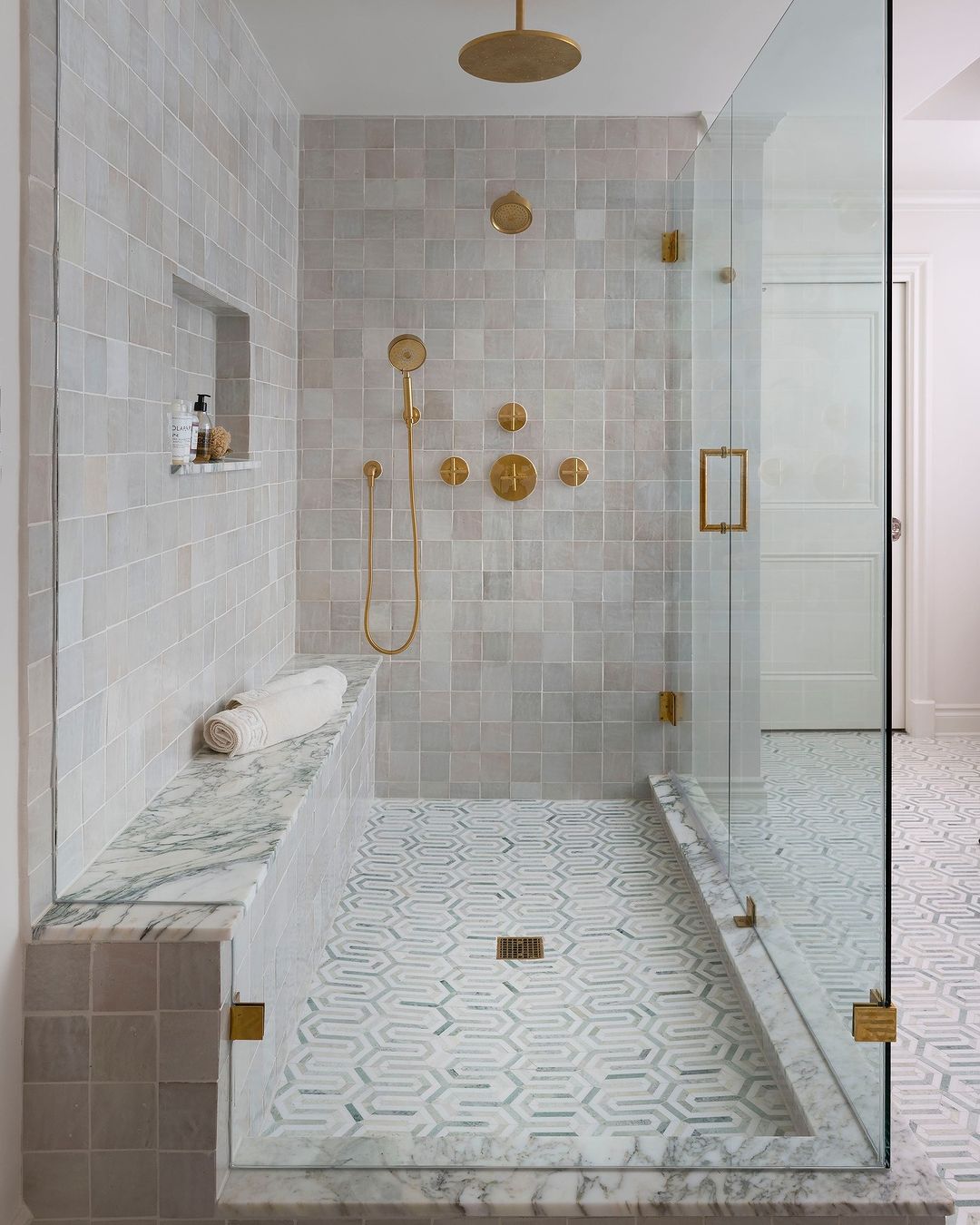 Exquisite Patterned Tile Shower with Marble Bench and Brass Fixtures - Best Shower Niche Ideas