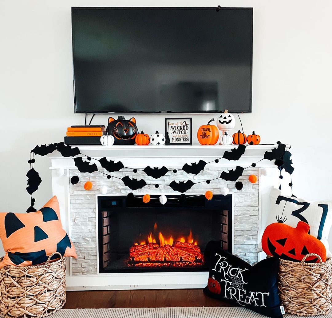 Playful Halloween Fireplace with Bat and Pumpkin Decor