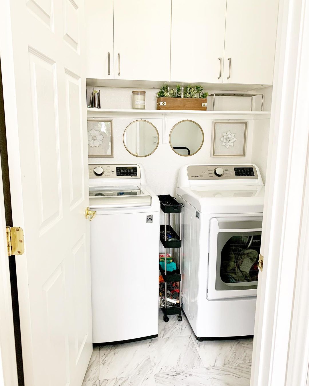 Bright Laundry Room with Mirrors and Marble Flooring