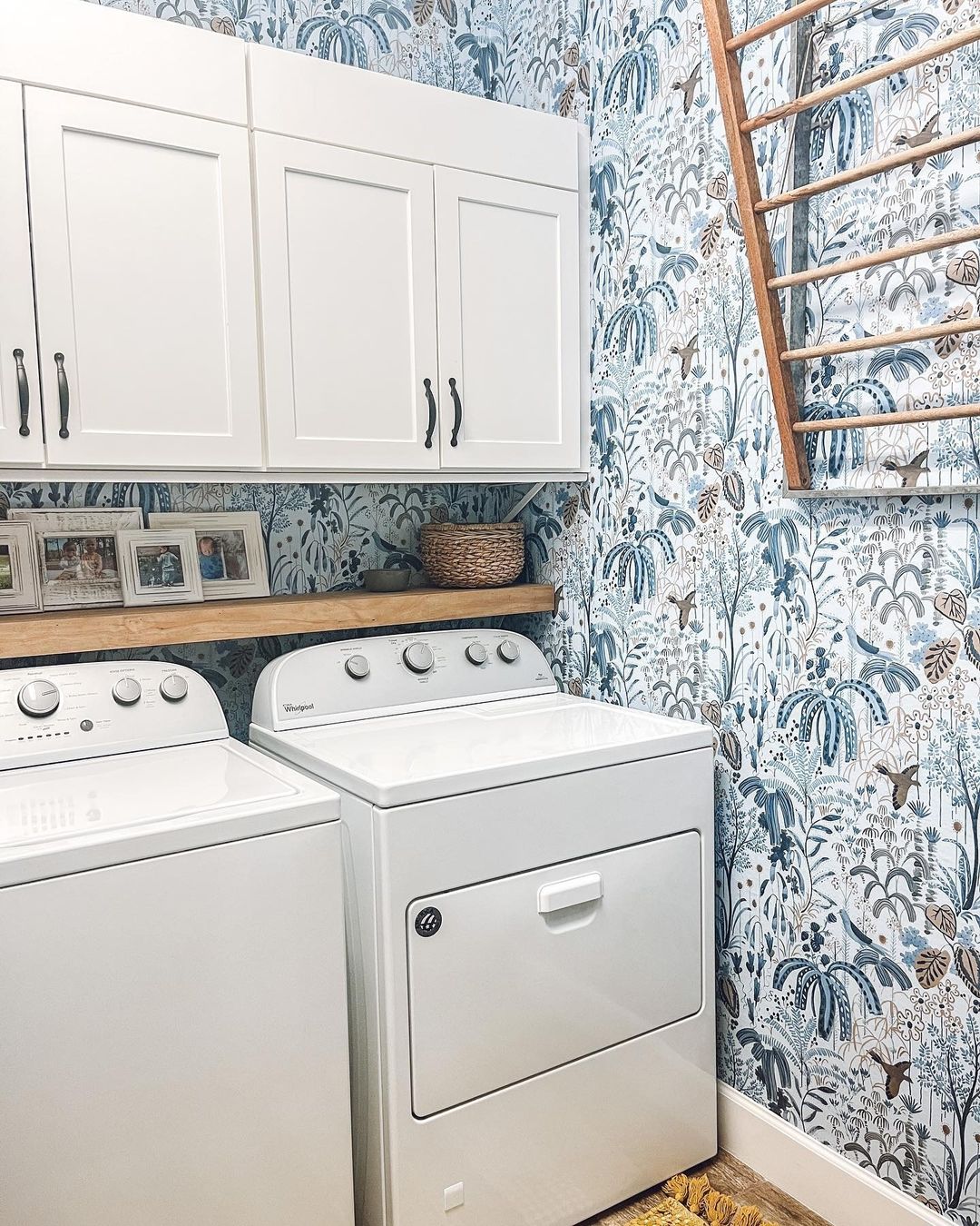 Bright Laundry Room with Botanical Wallpaper and White Cabinets