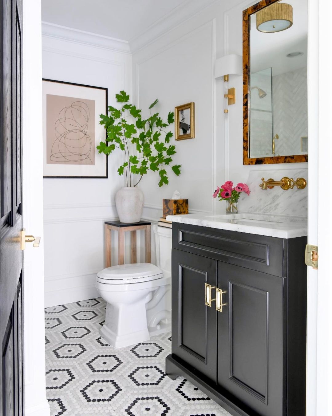 Monochrome Art and Elegant Fixtures for a Sophisticated Bathroom