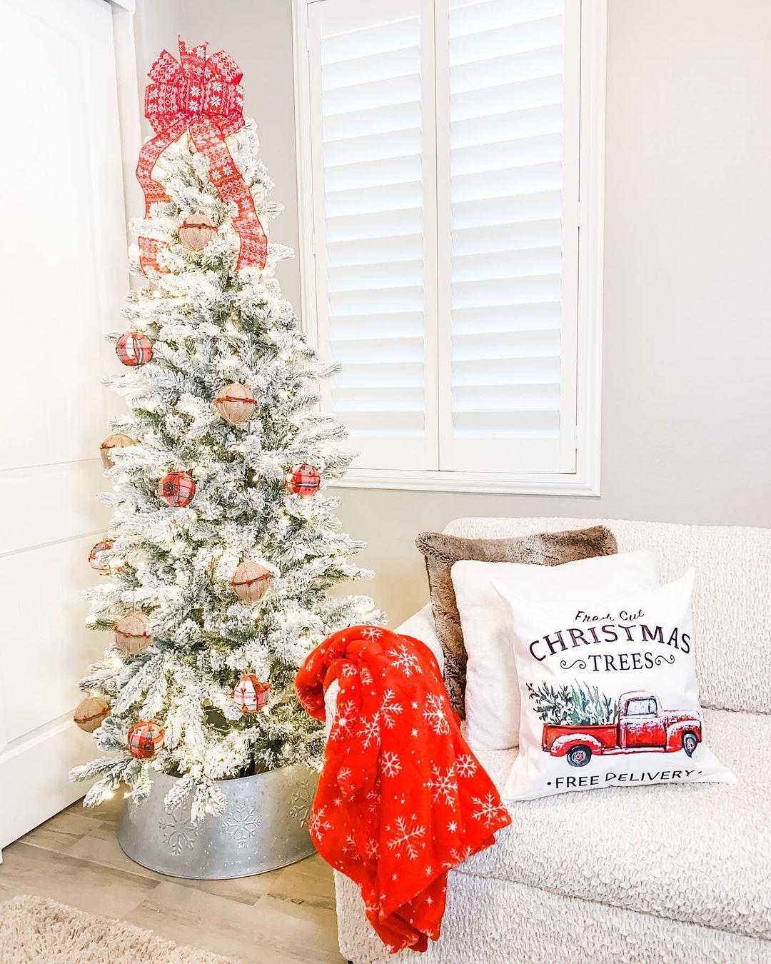 Add a Cozy Touch to Your Living Room with a Slim Christmas Tree and Bright Accents