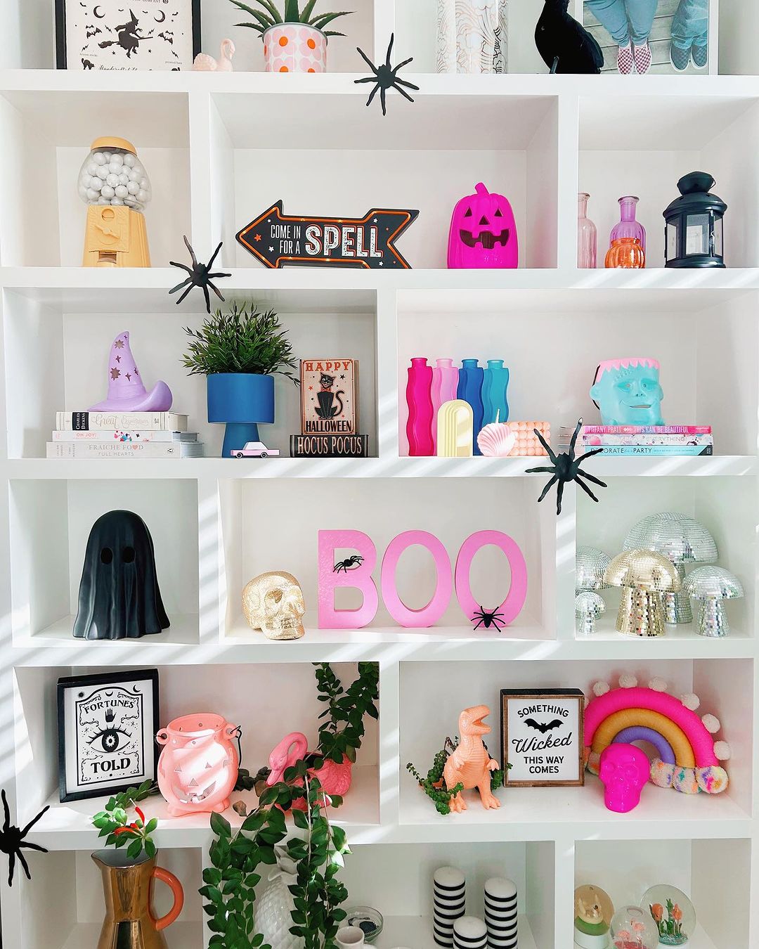 Vibrant Pink Halloween Shelf Display with Creative Touches