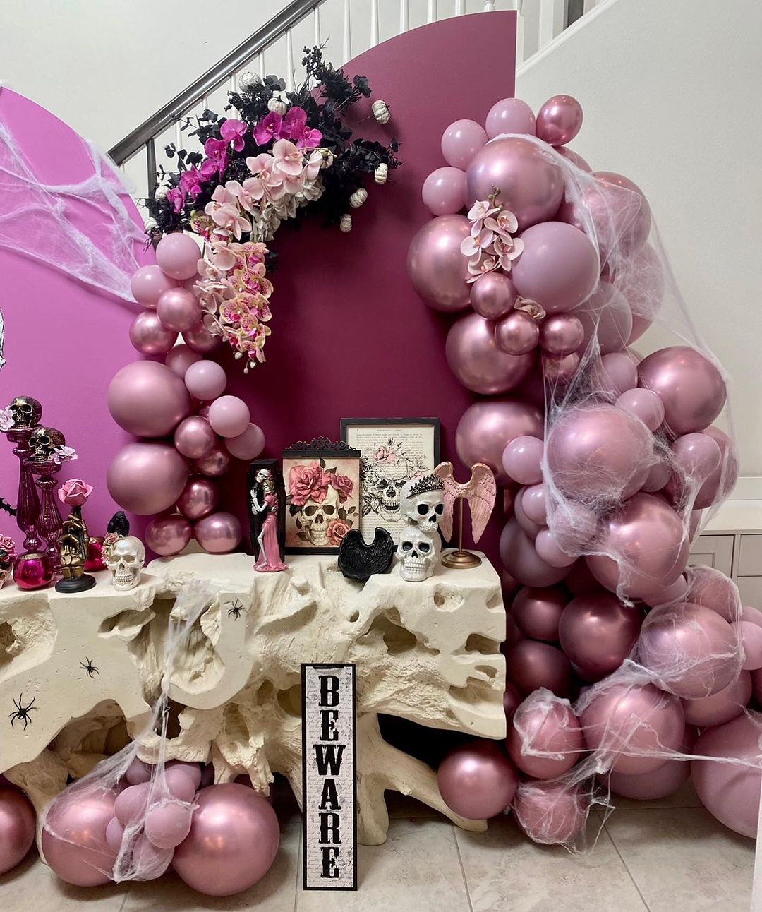 Extravagant Pink Halloween Balloon Display with Spooky Decor