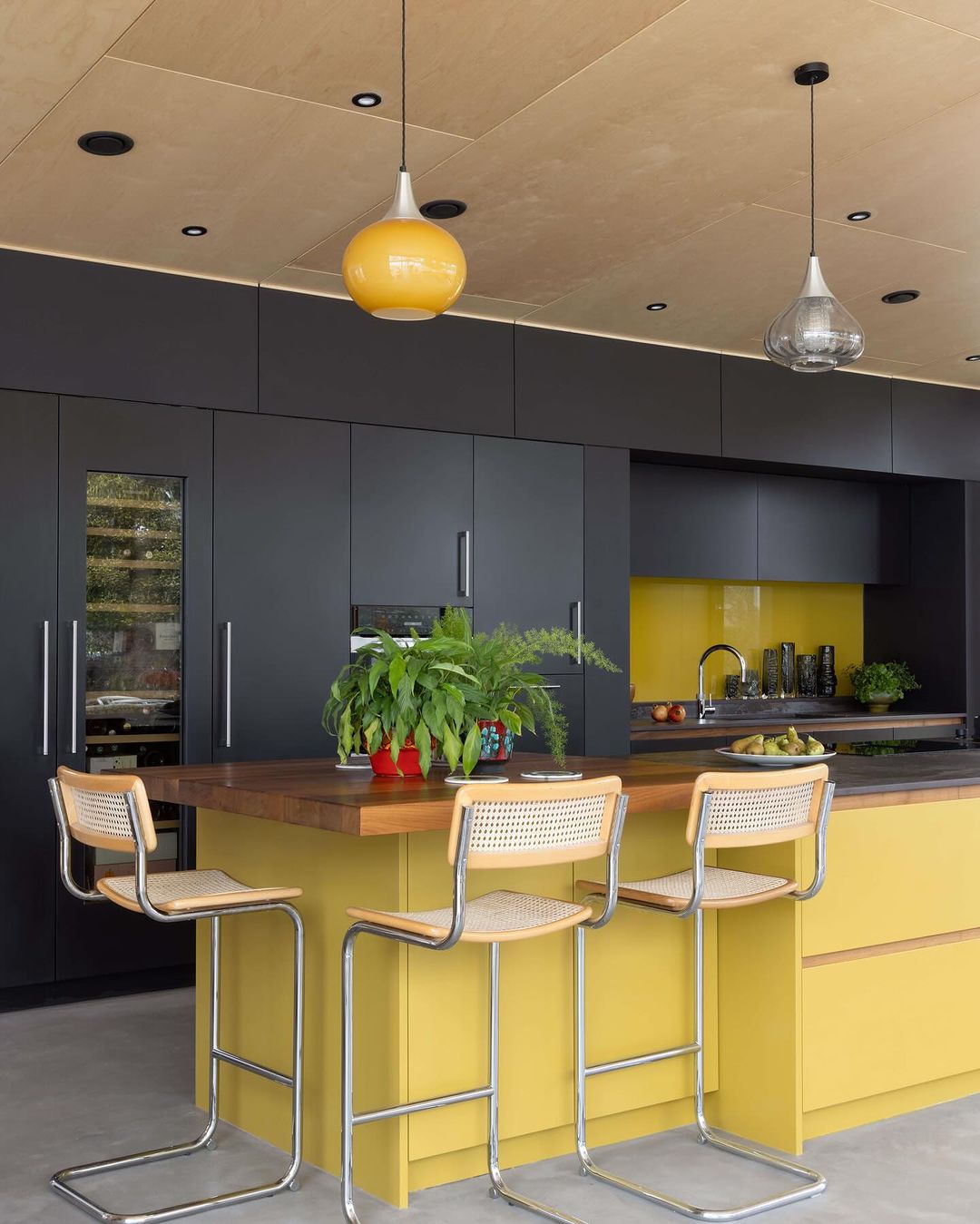 Sleek Yellow Island with Dark Cabinets