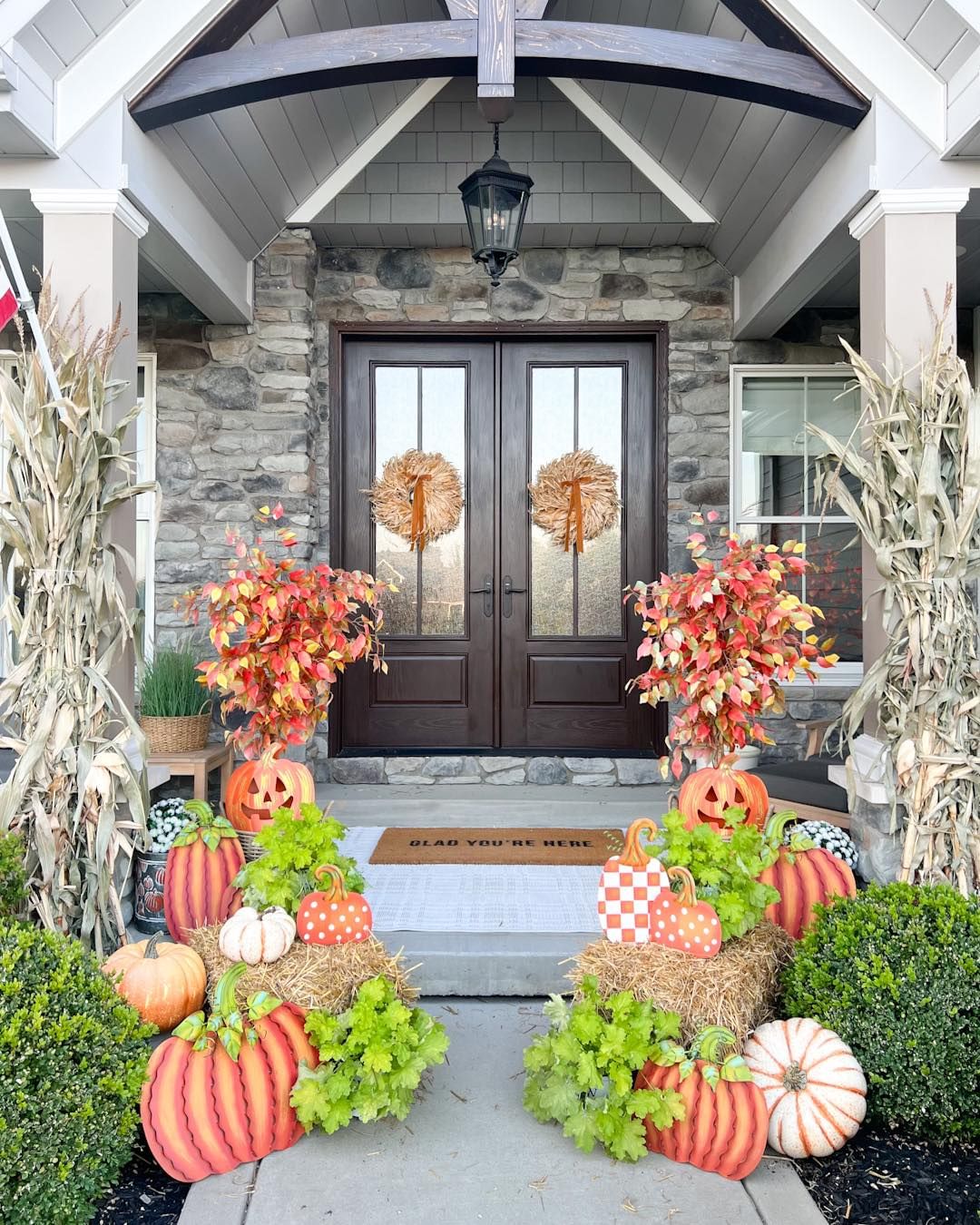 Vibrant Fall Porch with Corn Stalks and Pumpkins