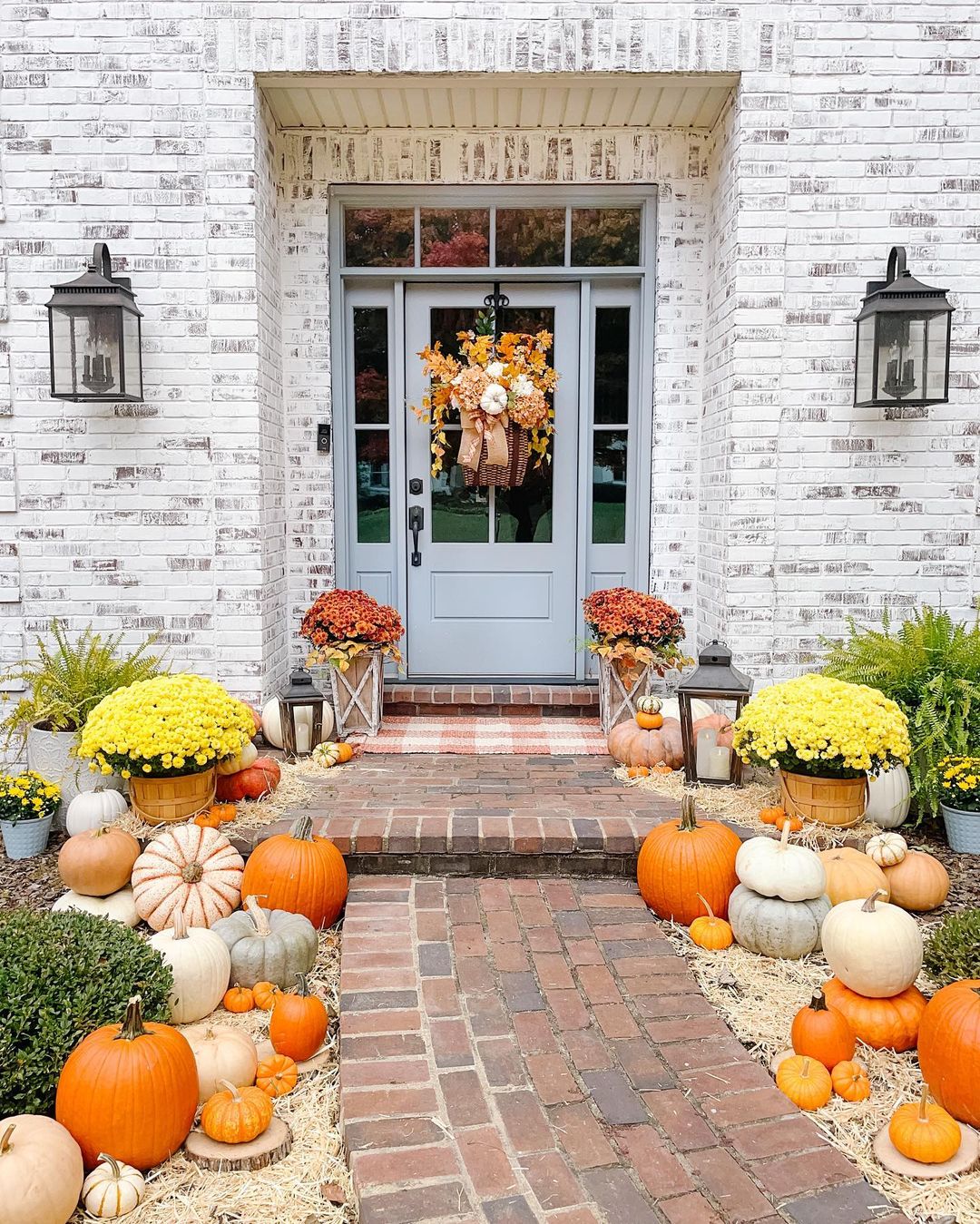 Classic Autumn Porch with Vibrant Mums and Pumpkins