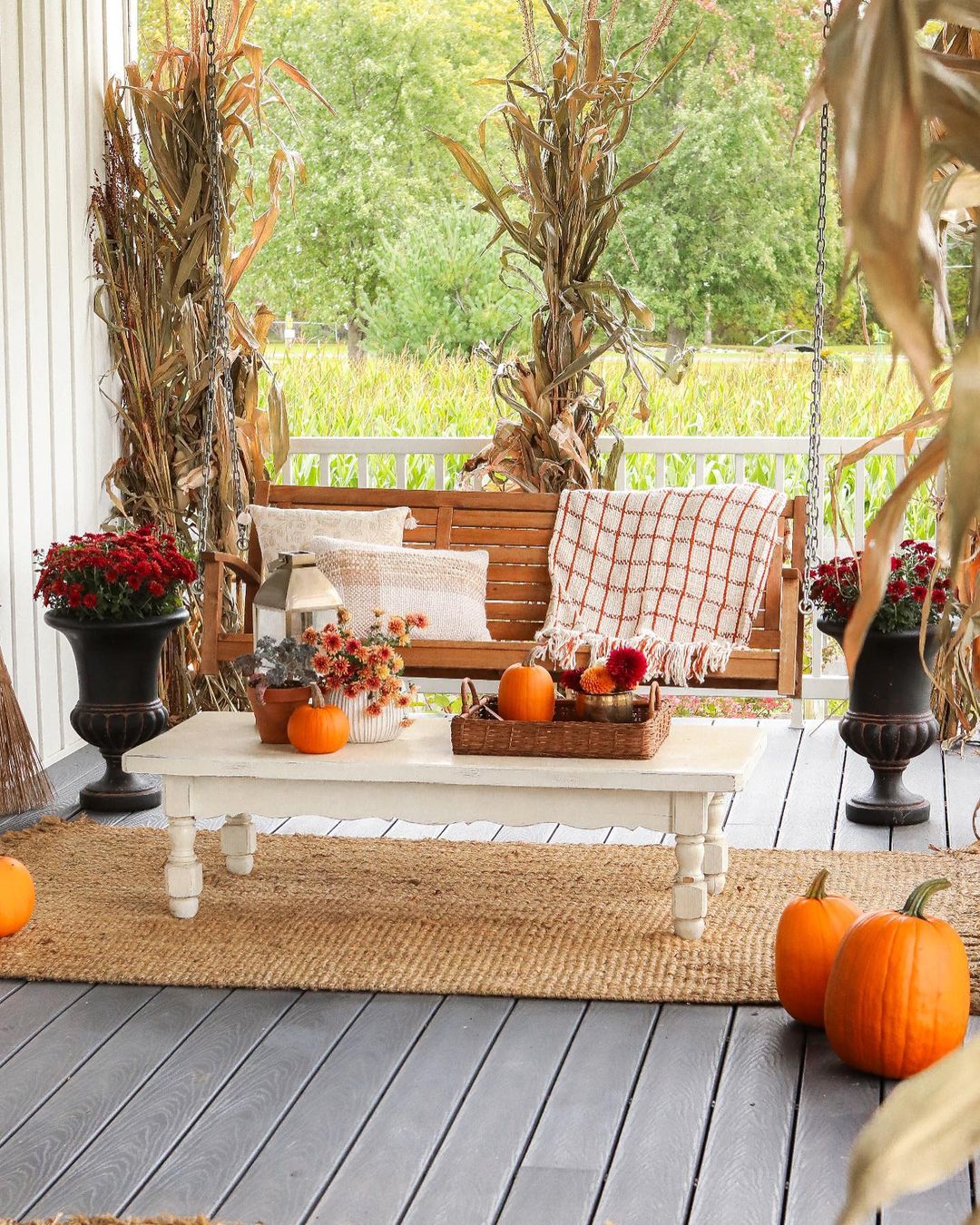 Rustic Fall Porch with Cozy Swing and Corn Stalks