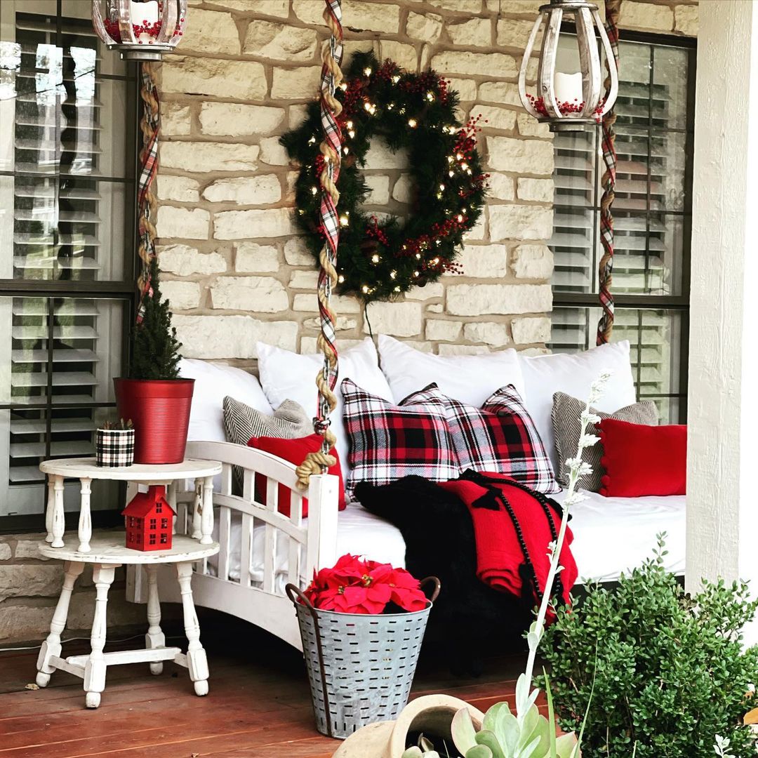 Cozy Christmas Porch with Plaid Pillows and Warm Accents