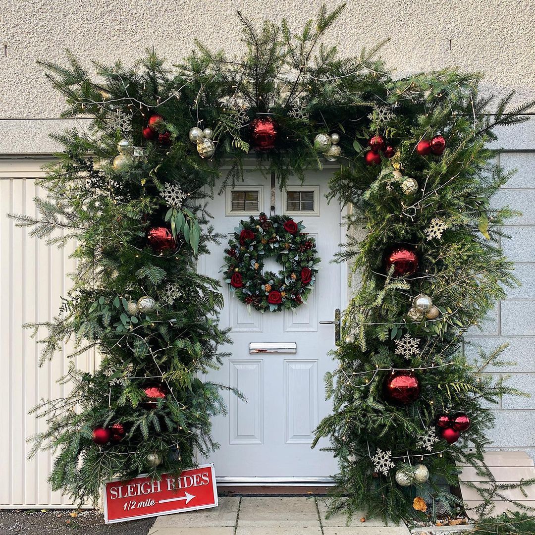 Lush Greenery with Oversized Ornaments for a Bold Christmas Entrance