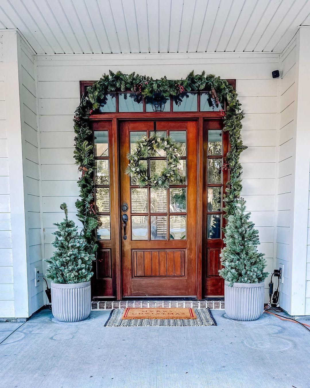 22. Simple and Natural Christmas Porch with Evergreen Accents