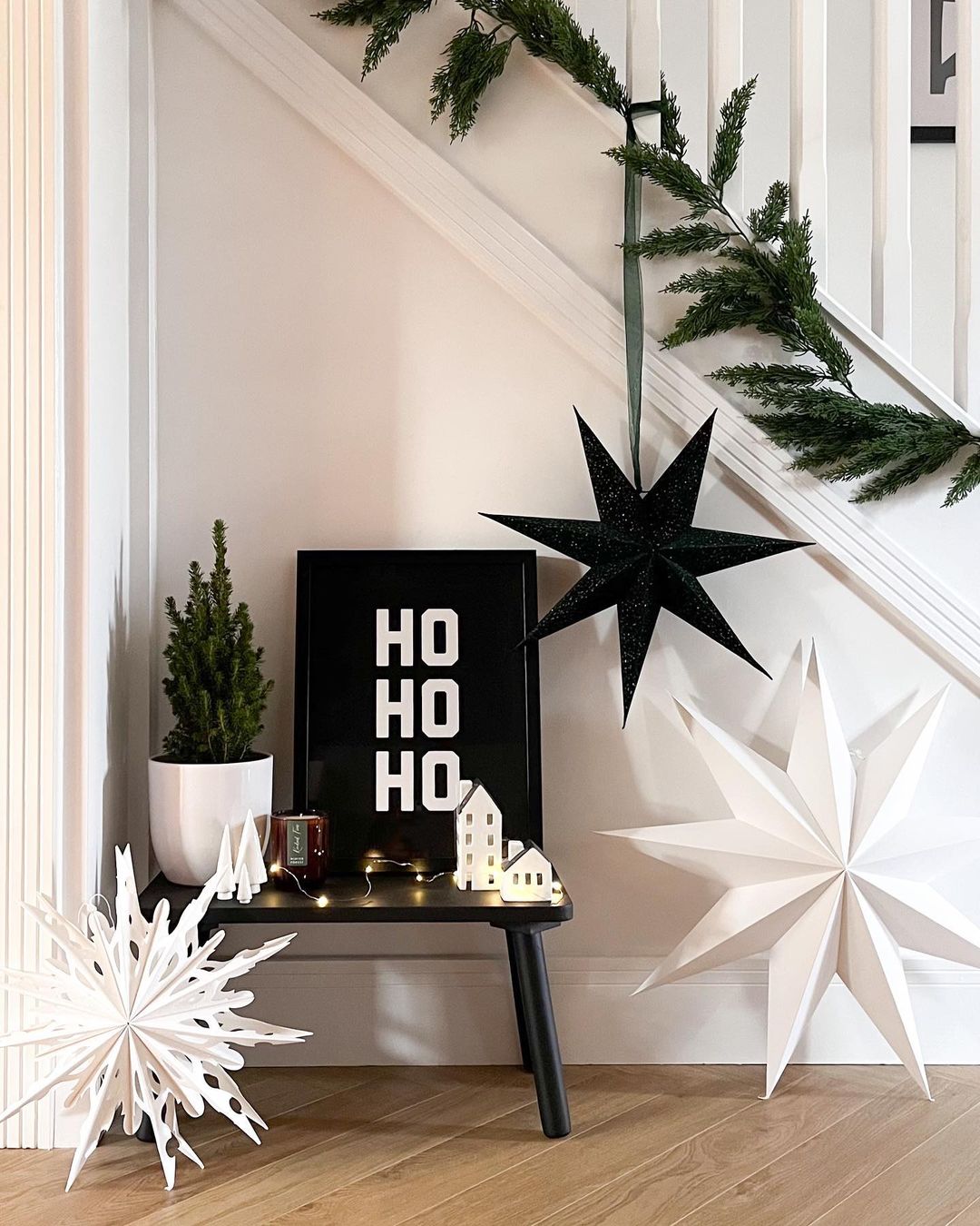 Minimalist Black and White Staircase with Bold Holiday Accents