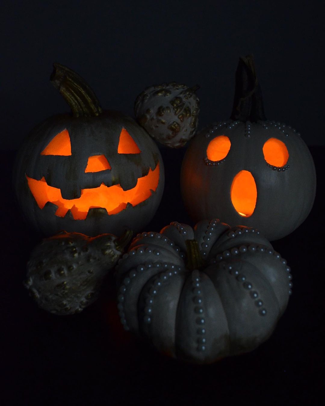 Elegant Painted Pumpkins with Classic Carvings for a Sophisticated Halloween