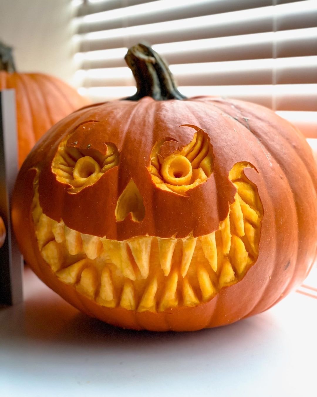 Intricately Carved Grinning Pumpkin for a Terrifying Halloween Display