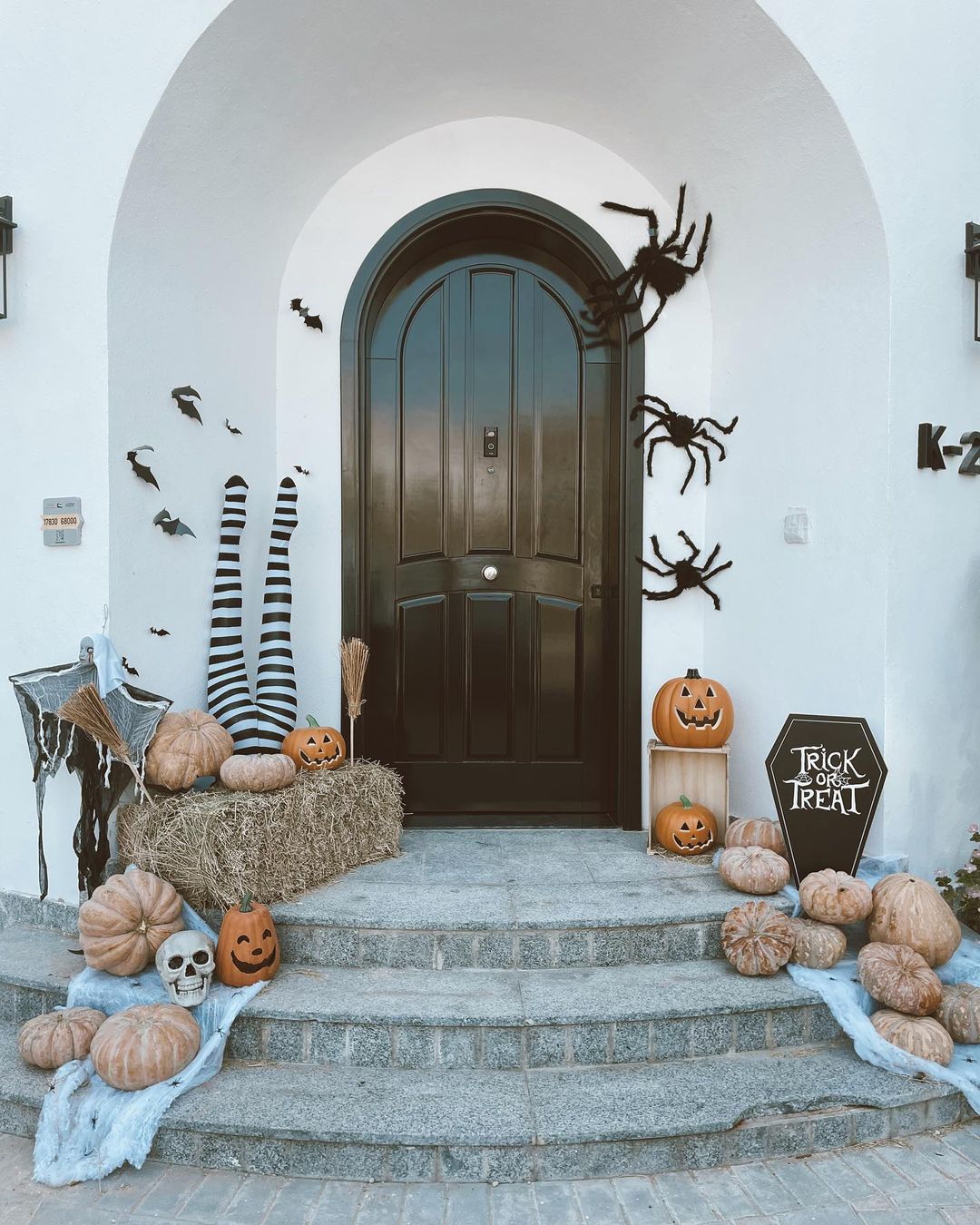 Spooky Halloween Porch with Oversized Spiders and Witch’s Legs