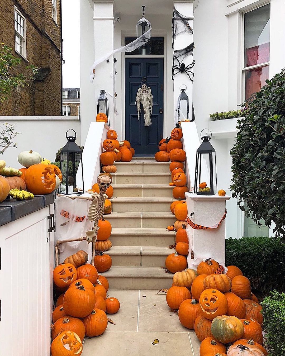 Pumpkin-Filled Staircase with Skeletons and Ghosts