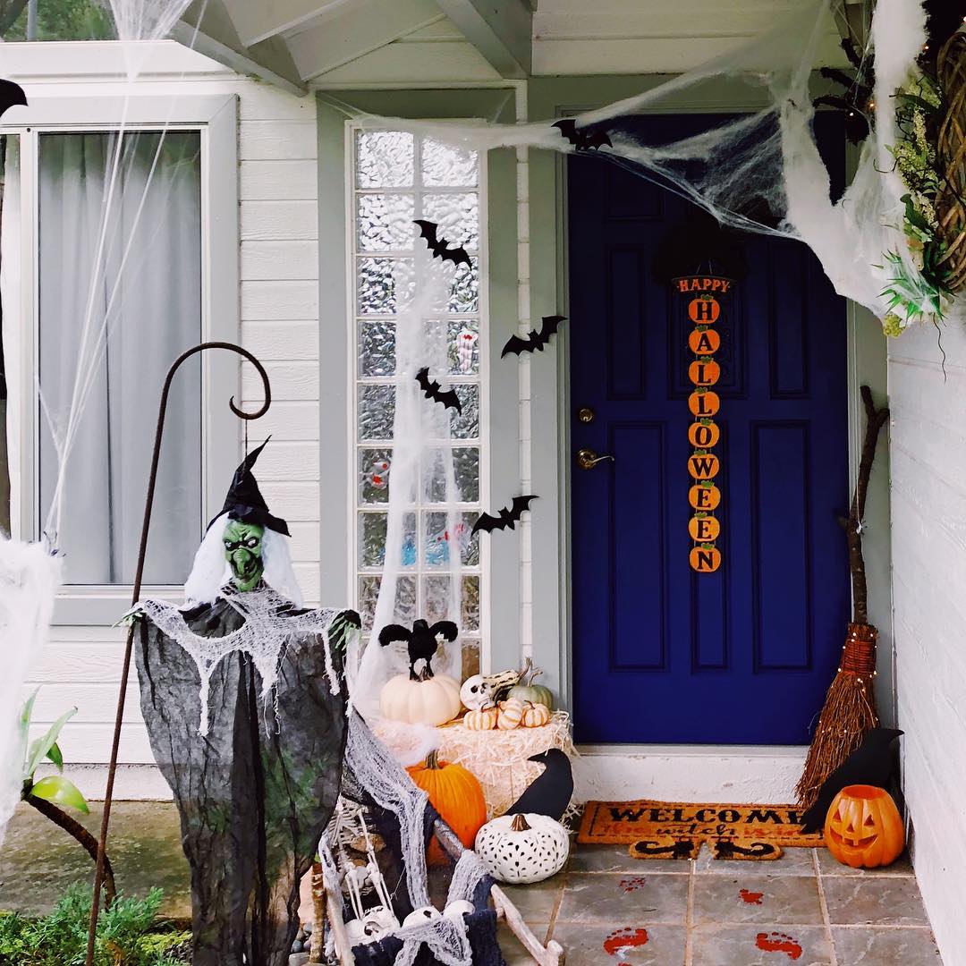 Spooky Witch-Themed Halloween Porch with Bats and Pumpkins