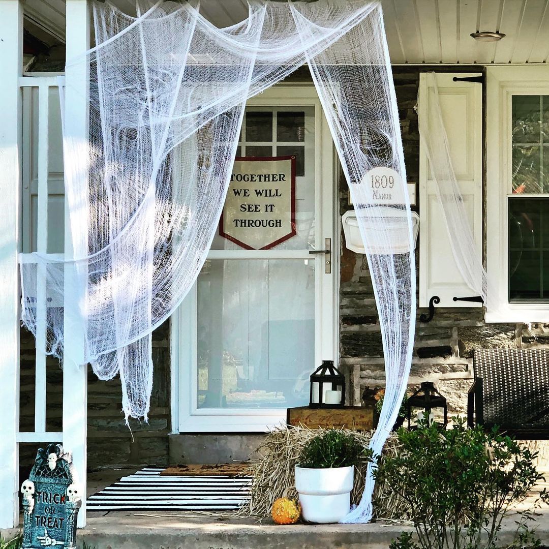 Cozy Halloween Porch with Cobweb Drapes and Subtle Spooky Touches