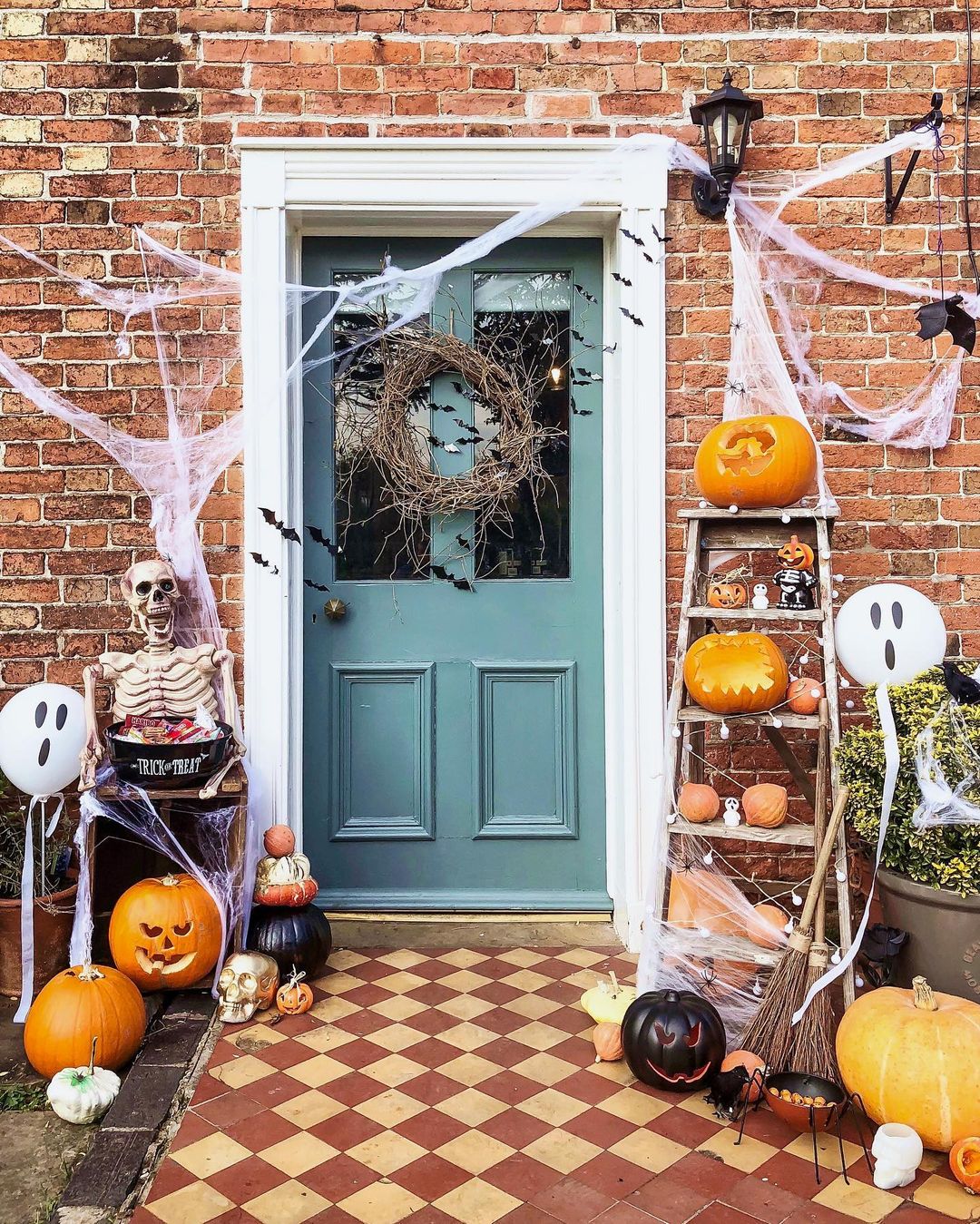 Classic Spooky Halloween Entrance with Pumpkin Display