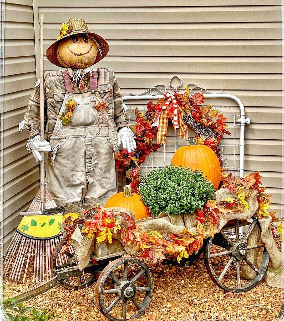 25. Create a Charming Fall Outdoor Display with a Scarecrow and Rustic Wagon