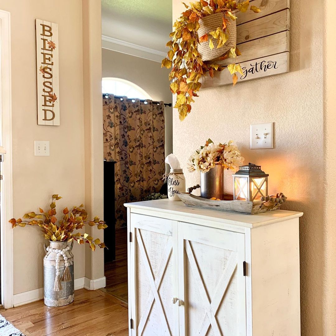 Welcoming Rustic Fall Entryway with Warm Lighting and Autumn Accents