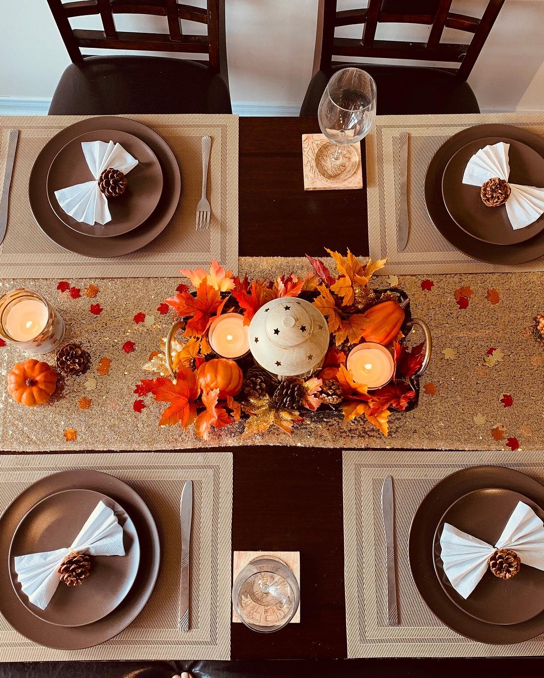 Cozy Autumn Table with Pinecones and Warm Candlelight