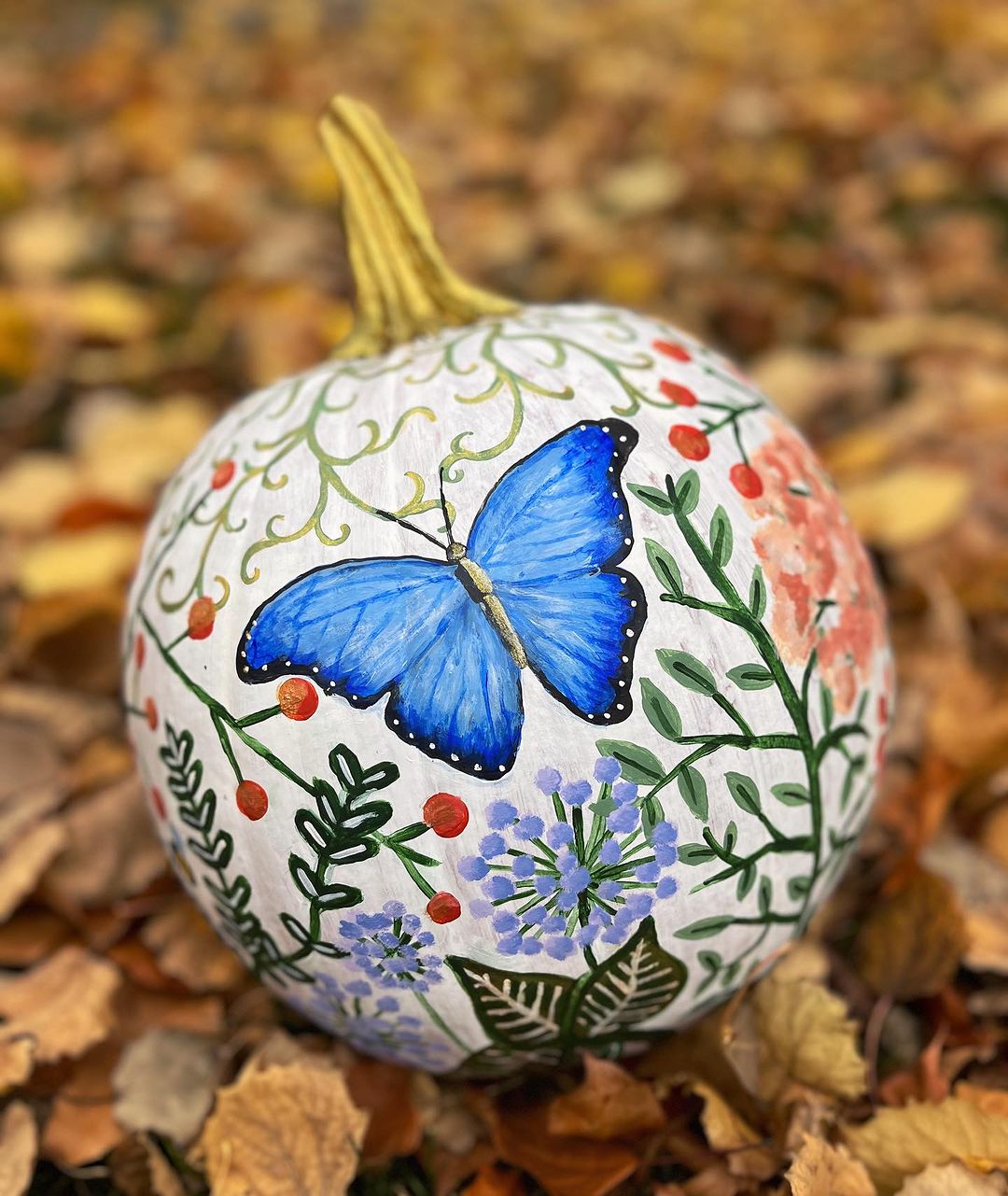 Enchanting Butterfly and Floral Design on a White Pumpkin