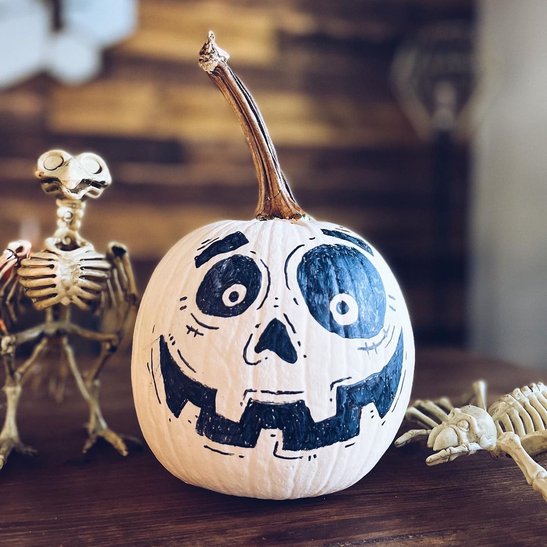 Playful Skeleton Face Painted on a White Pumpkin