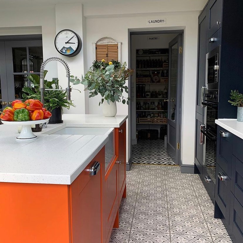 Bold Orange Cabinets Paired With Navy Elegance