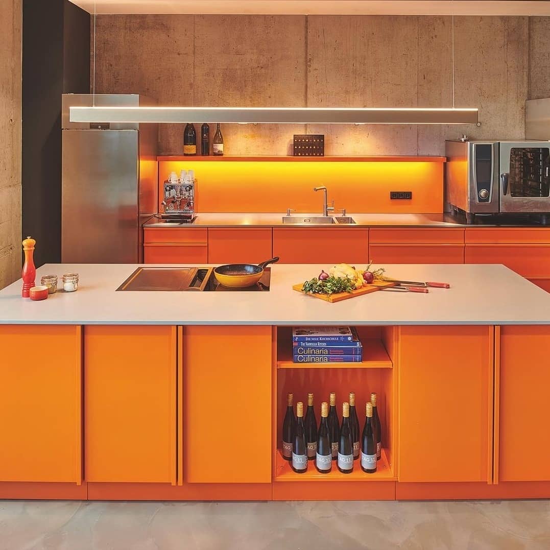 Vibrant Orange Cabinets With Industrial Edge