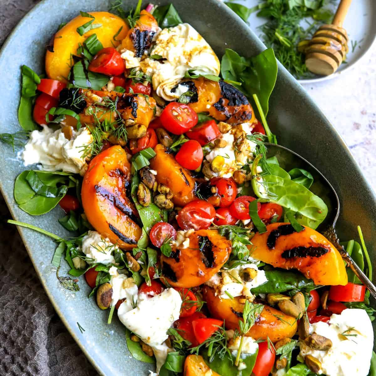 Grilled Peach and Burrata Salad with Lemon Herb Vinaigrette and Pistachios